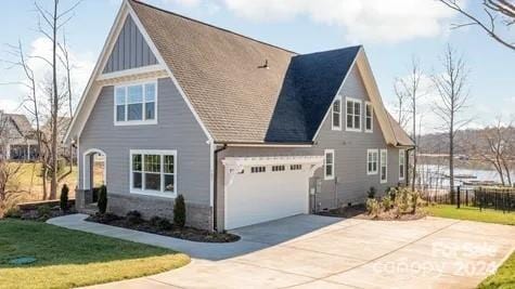 view of side of property with a garage and a lawn