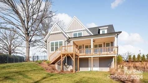 rear view of house with a yard and ceiling fan