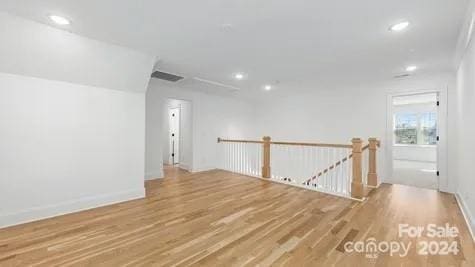 spare room with wood-type flooring