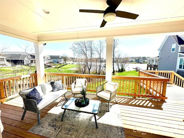 wooden deck featuring an outdoor hangout area and ceiling fan