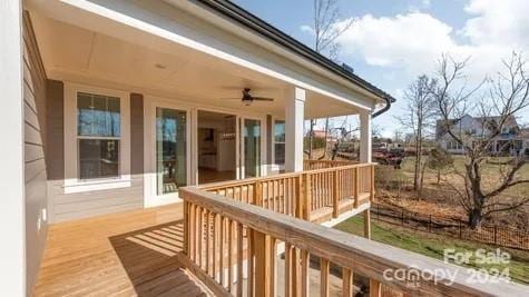 wooden deck featuring ceiling fan