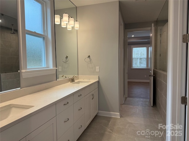 bathroom featuring a healthy amount of sunlight, tile patterned flooring, and vanity