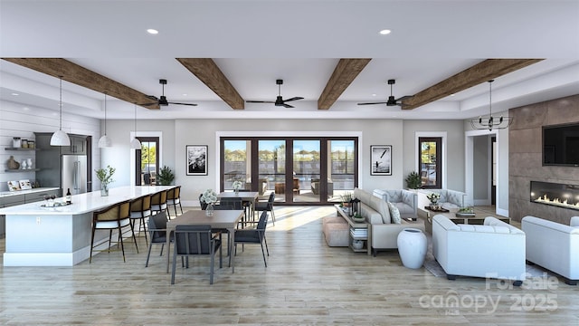 living room featuring a tiled fireplace, light wood-type flooring, french doors, and a wealth of natural light