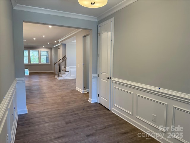 corridor featuring dark wood-type flooring and crown molding