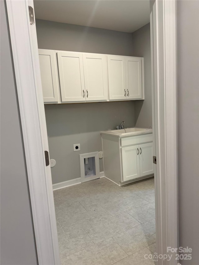 laundry area with sink, electric dryer hookup, washer hookup, and cabinets