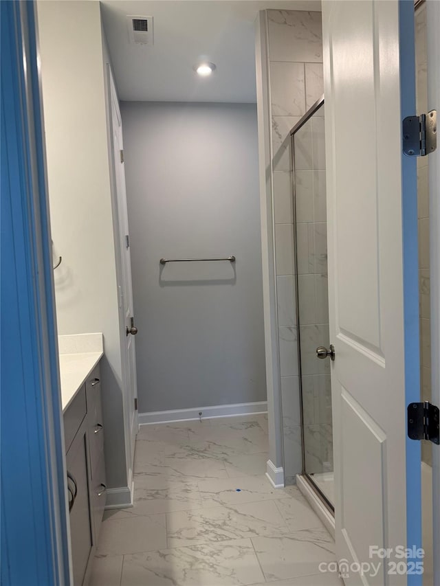 bathroom with walk in shower and vanity