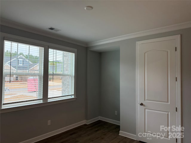 unfurnished room with crown molding and dark hardwood / wood-style flooring