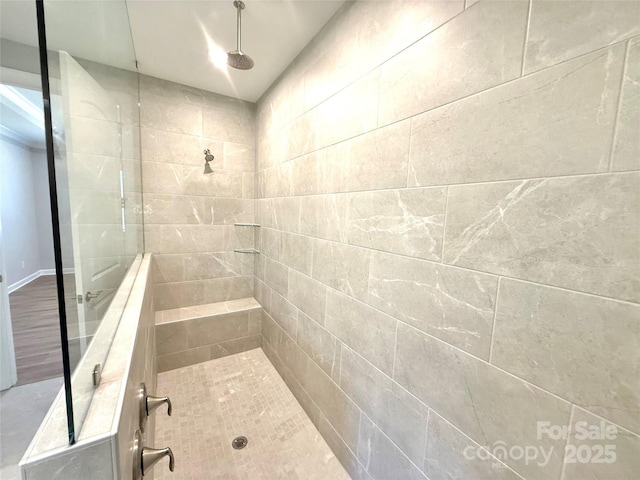 full bath featuring tiled shower