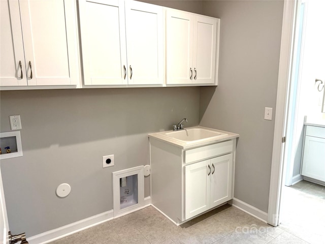 clothes washing area featuring baseboards, hookup for a washing machine, cabinet space, hookup for an electric dryer, and a sink