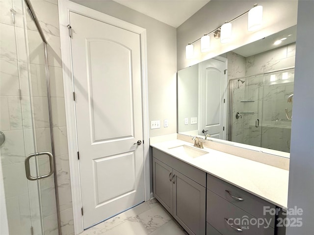 full bath featuring marble finish floor, a stall shower, and vanity