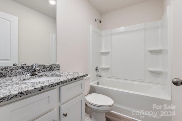 full bathroom featuring vanity, toilet, wood-type flooring, and shower / washtub combination