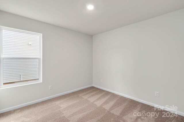 empty room with light colored carpet