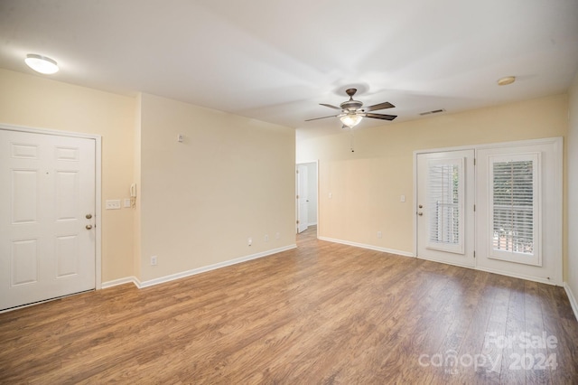 spare room with light wood-type flooring and ceiling fan