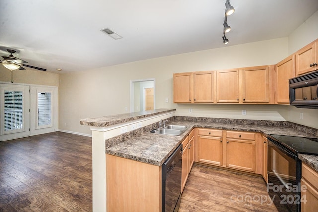 kitchen featuring black appliances, sink, kitchen peninsula, ceiling fan, and dark wood-type flooring