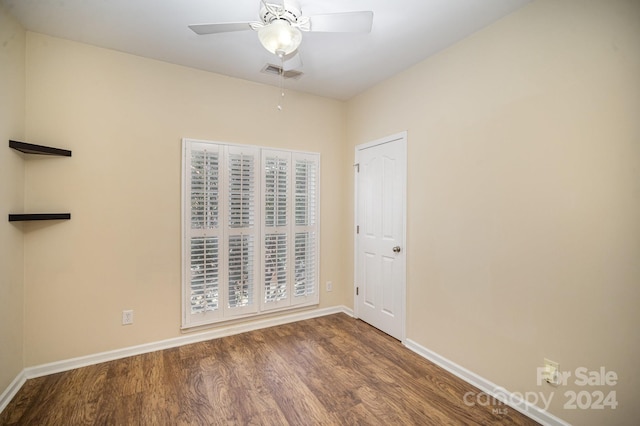 unfurnished room with ceiling fan and hardwood / wood-style flooring