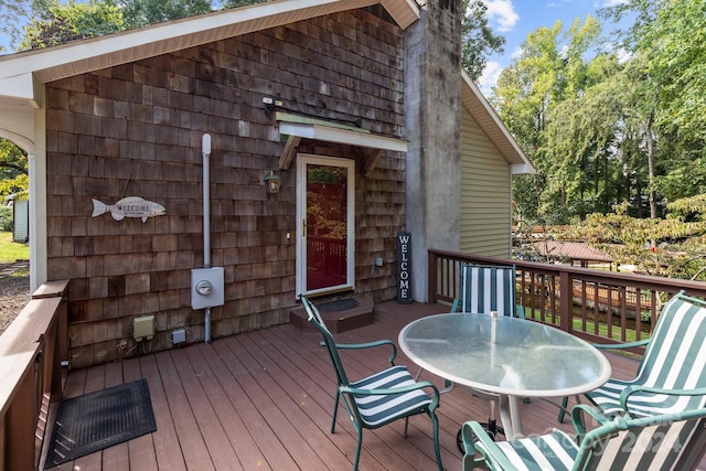 wooden deck featuring outdoor dining area