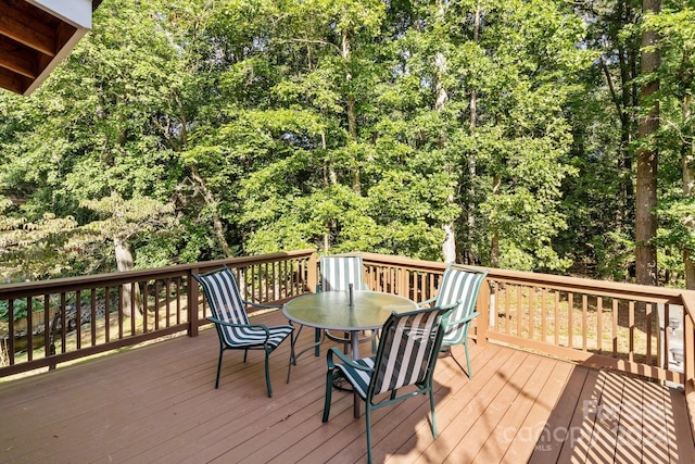 wooden terrace with outdoor dining space