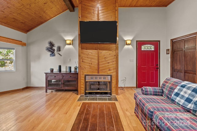 living room featuring high vaulted ceiling, hardwood / wood-style flooring, a fireplace, and beam ceiling