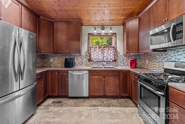 kitchen with wooden ceiling, decorative backsplash, a sink, and stainless steel appliances