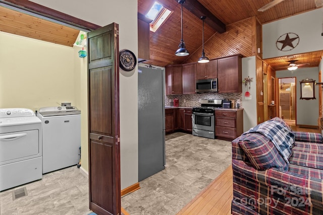 kitchen featuring washer and clothes dryer, hanging light fixtures, stainless steel appliances, ceiling fan, and vaulted ceiling with beams