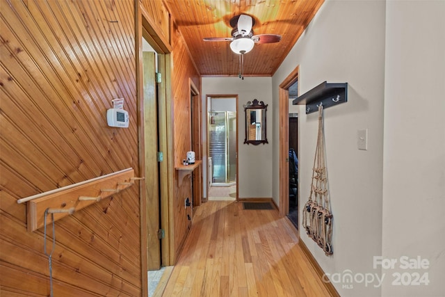 hall with wood ceiling and light wood finished floors