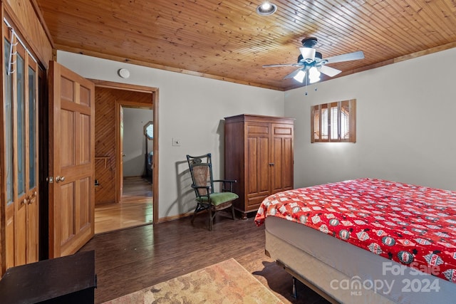 bedroom featuring dark wood-type flooring, ceiling fan, and wooden ceiling