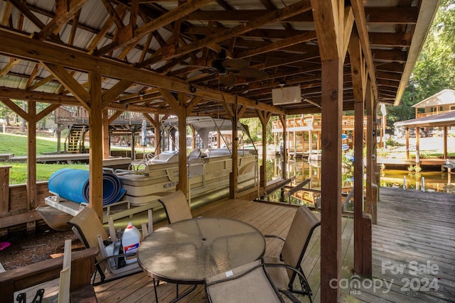 wooden terrace featuring boat lift and a dock