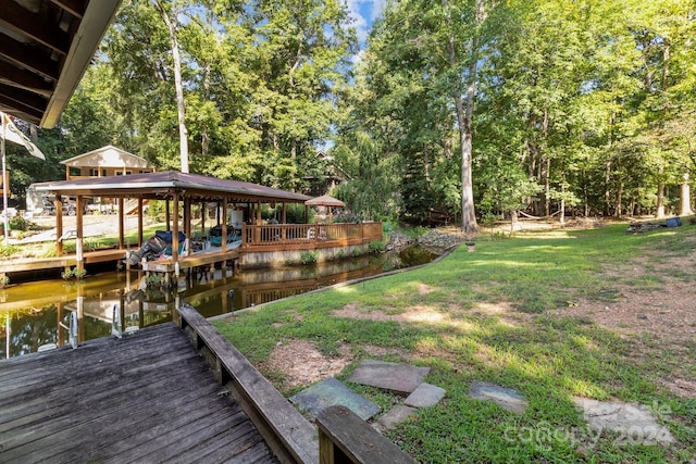 view of dock featuring a water view and a lawn