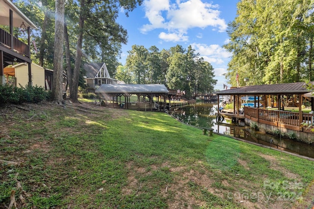 view of yard with a boat dock and a water view