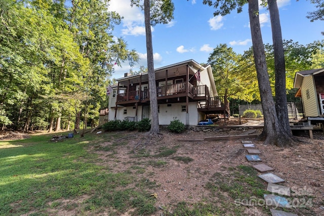 rear view of house with a yard and a deck