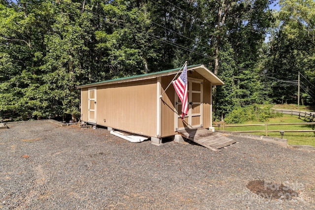 view of shed featuring fence