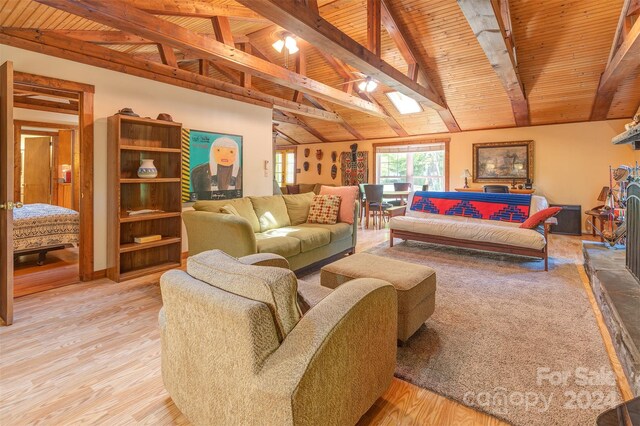 living room featuring wood ceiling, light hardwood / wood-style flooring, and lofted ceiling with skylight