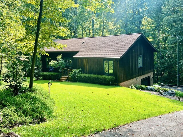 view of front of property with a garage and a front lawn