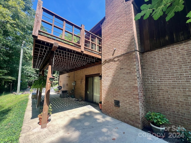 back of house featuring brick siding, crawl space, a patio area, and central air condition unit