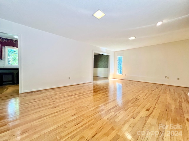 unfurnished room featuring light wood-style flooring and baseboards