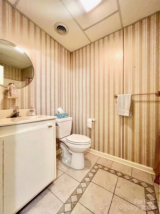 bathroom with toilet and wallpapered walls