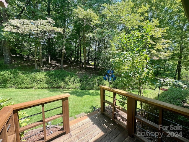 wooden deck featuring a yard