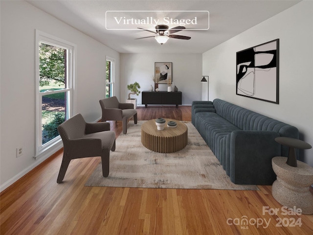 living room with ceiling fan, a wealth of natural light, and light hardwood / wood-style floors