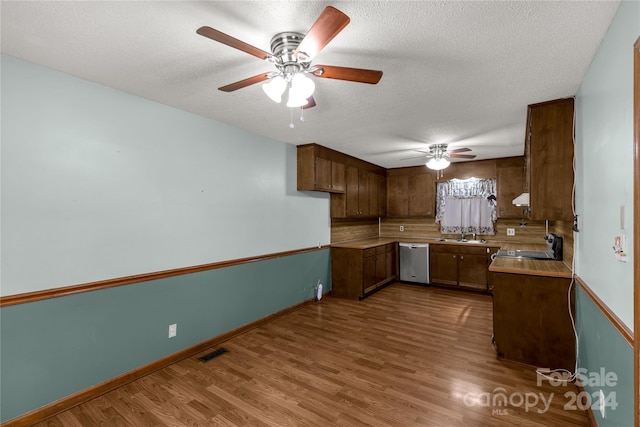 kitchen featuring dishwasher, ceiling fan, black range oven, and hardwood / wood-style floors