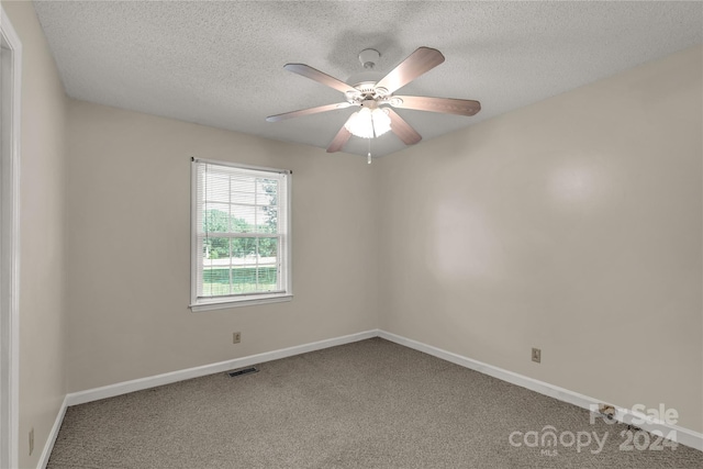 spare room featuring a textured ceiling, carpet flooring, and ceiling fan