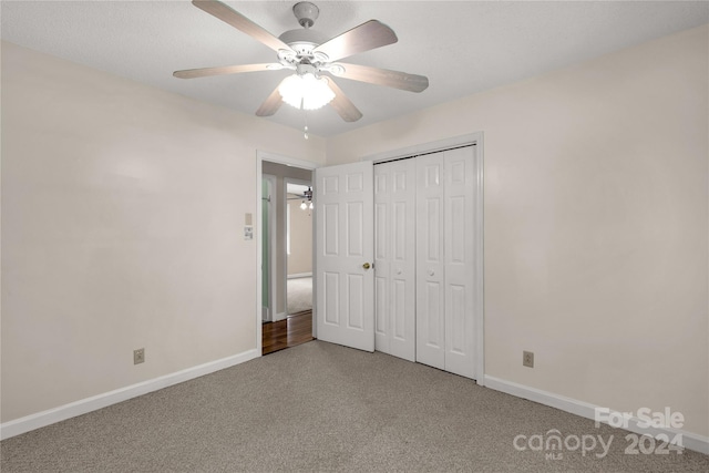 unfurnished bedroom featuring a closet, ceiling fan, and carpet floors