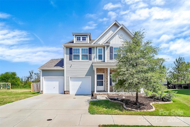 view of front of property featuring a garage and a front lawn