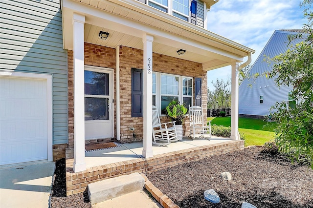 doorway to property featuring a garage and a porch