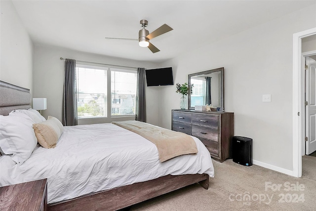 bedroom featuring ceiling fan and light carpet