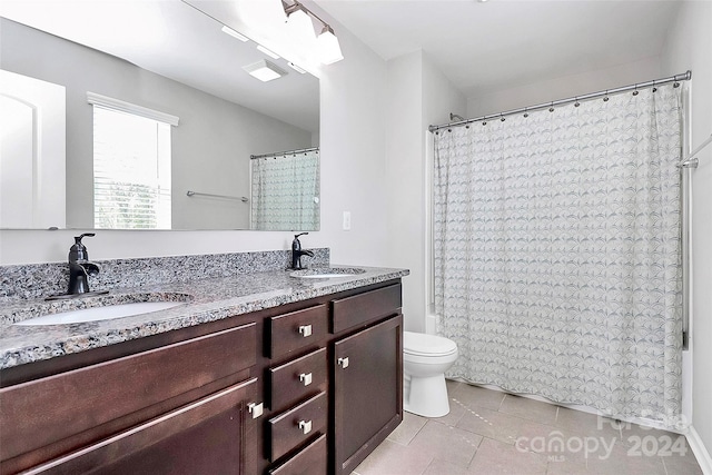 full bathroom featuring vanity, toilet, tile patterned floors, and shower / bath combo with shower curtain