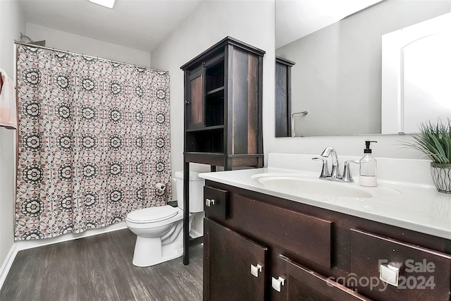 bathroom featuring vanity, toilet, a shower with curtain, and hardwood / wood-style flooring