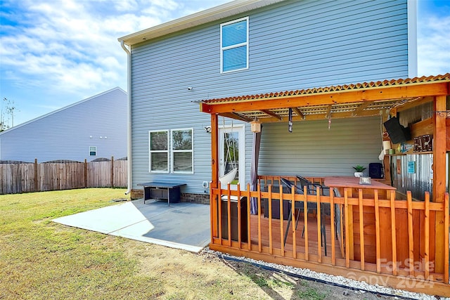 back of house with a yard and a patio