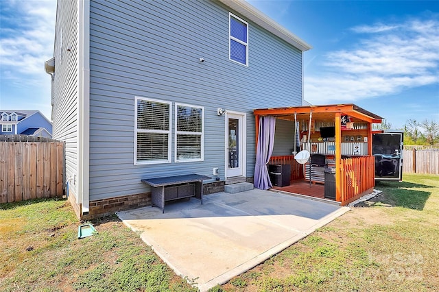 rear view of property featuring a yard and a patio area