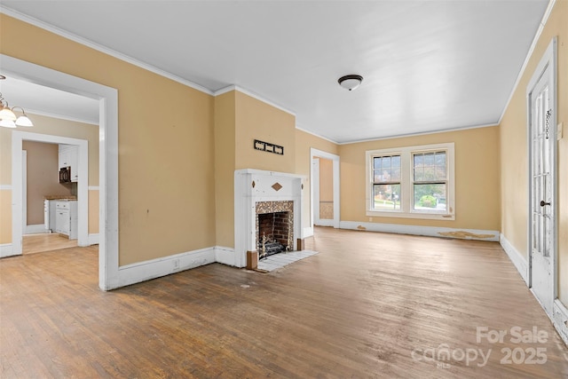 unfurnished living room with hardwood / wood-style flooring, a chandelier, and ornamental molding