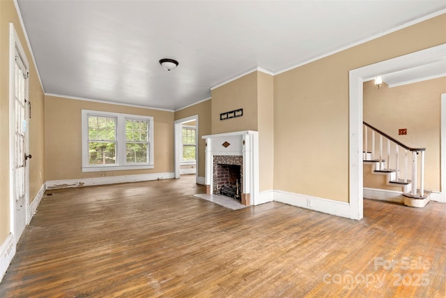 unfurnished living room with hardwood / wood-style flooring and crown molding